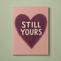 Still Yours card: a brush-painted plum heart on a dusty rose card with cream lettering