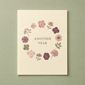 Another Year card: twelve pressed flower shapes painted in a ring on a cream card