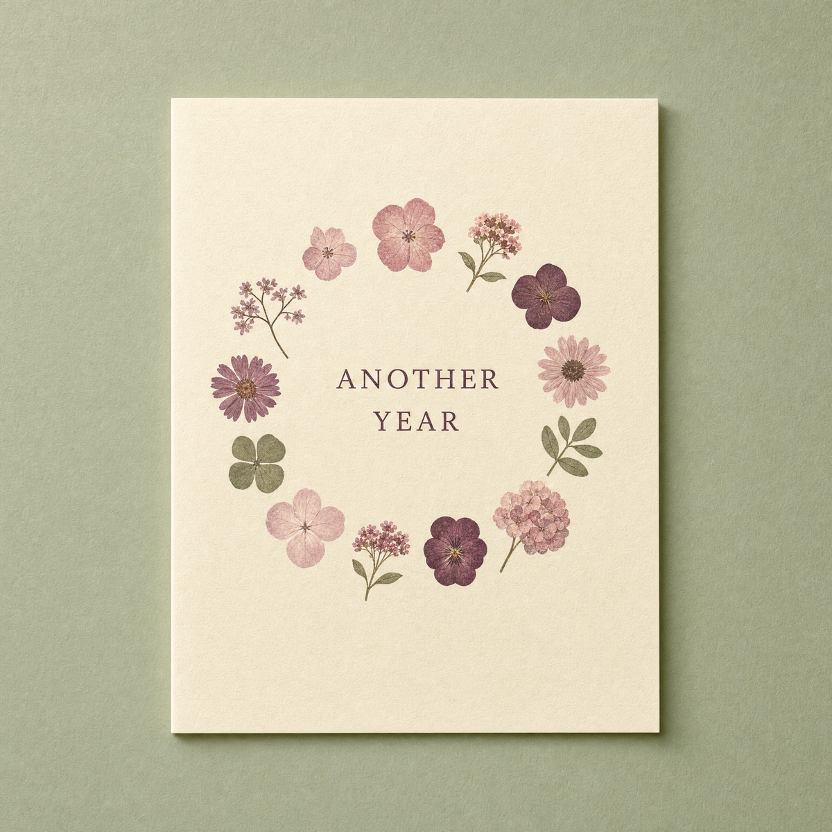Another Year card: twelve pressed flower shapes painted in a ring on a cream card