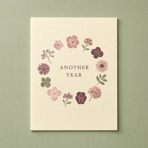 Another Year card: twelve pressed flower shapes painted in a ring on a cream card