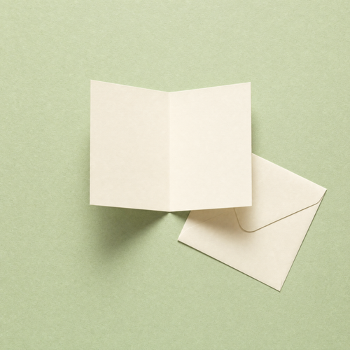 The A6 card open, showing the blank cream inside, with its small envelope beside it