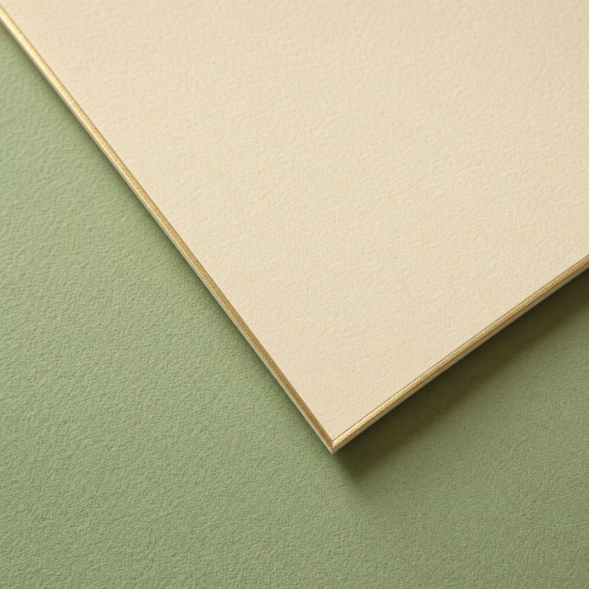 Corner of the card showing the uncoated 320gsm board and the gold foil edge